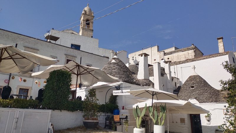 Alberobelloː Trullo direlakoak, harrizko sabai konikoa duten etxeak.